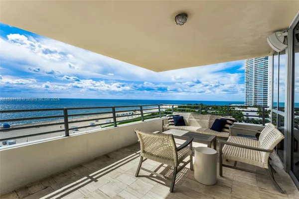 a terrace with outdoor seating and city view