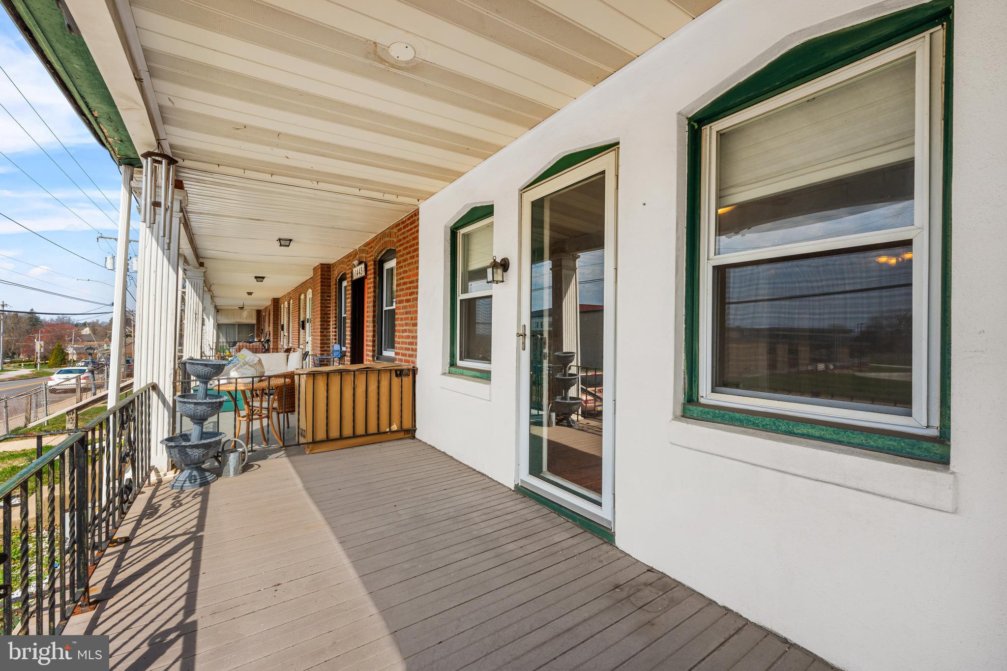 1441 Lawrence Road Havertown, PA 19083 - Photo 3 of 13 a view of a porch with wooden floor and iron stairs