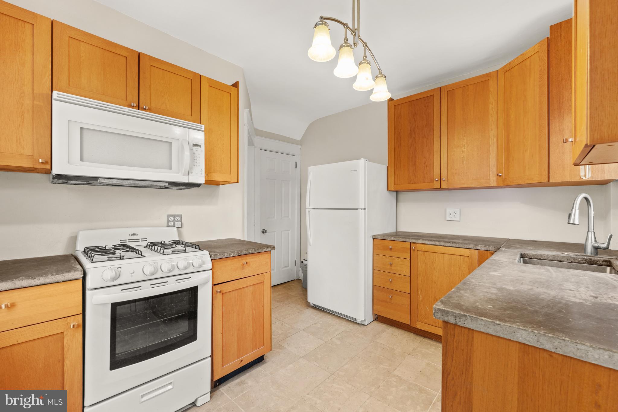 1441 Lawrence Road Havertown, PA 19083 - Photo 6 of 13 a kitchen with stainless steel appliances granite countertop cabinets and a stove top oven