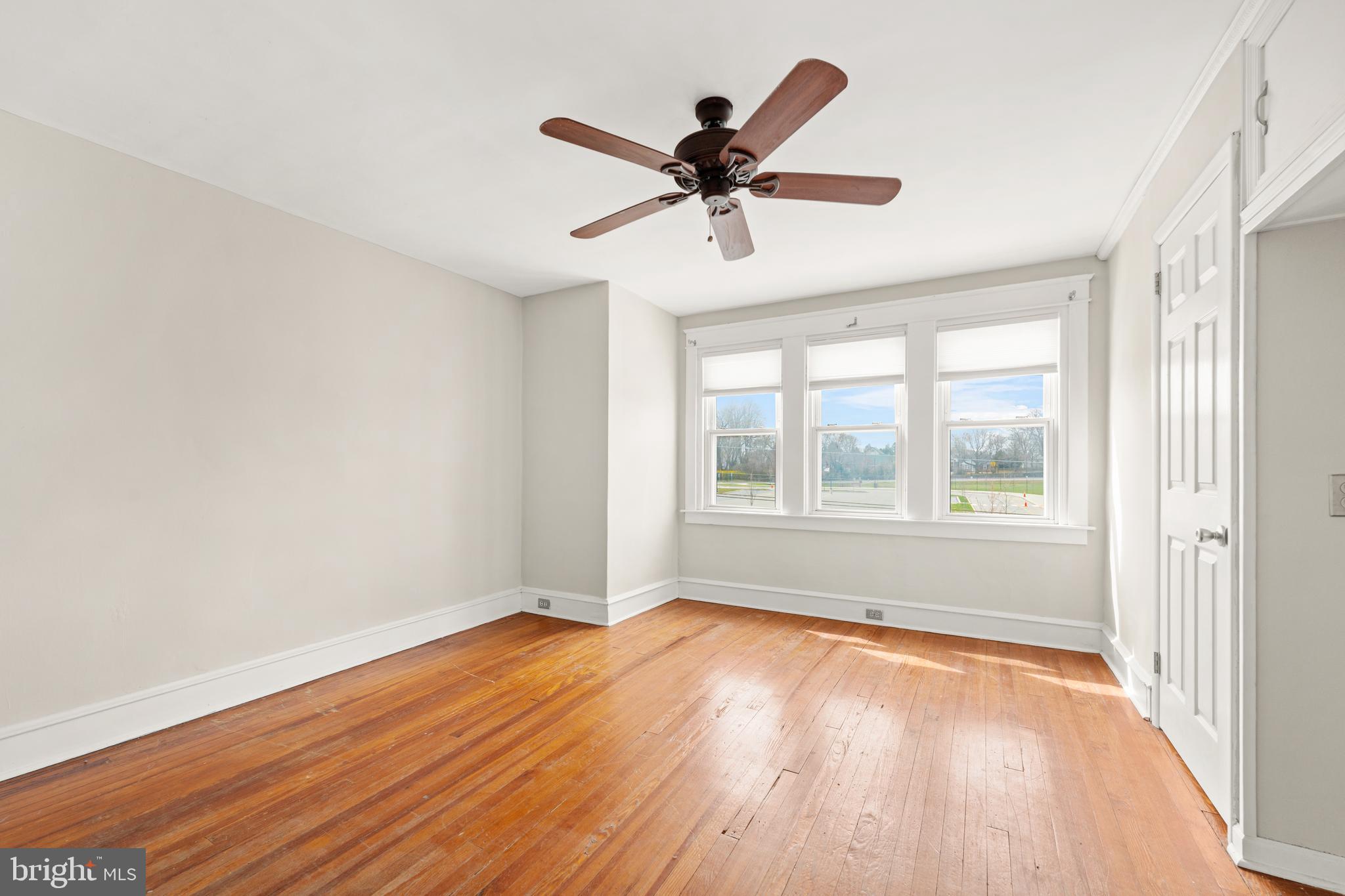 1441 Lawrence Road Havertown, PA 19083 - Photo 8 of 13 an empty room with wooden floor fan and windows
