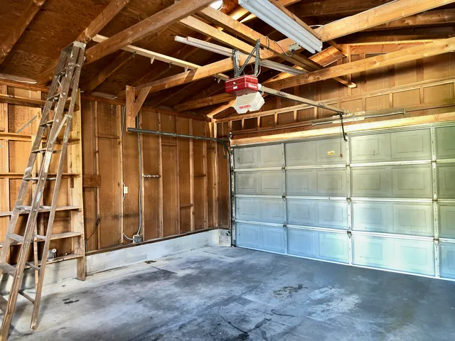 a kitchen with granite countertop a refrigerator and a stove top oven
