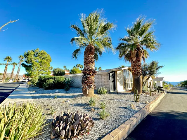 a view of house with outdoor space and sitting area
