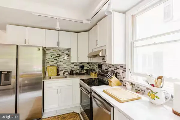 a kitchen with a sink stove and refrigerator