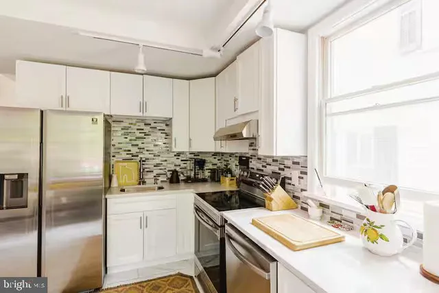 a kitchen with a sink stove and refrigerator