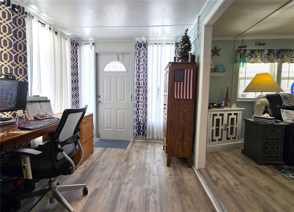 5619 Bayshore Road, Unit 435 Palmetto, FL 34221 - Photo 7 of 56 a workspace with wooden floor and furniture