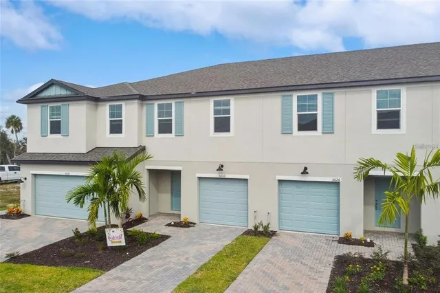 a front view of house with yard and trees