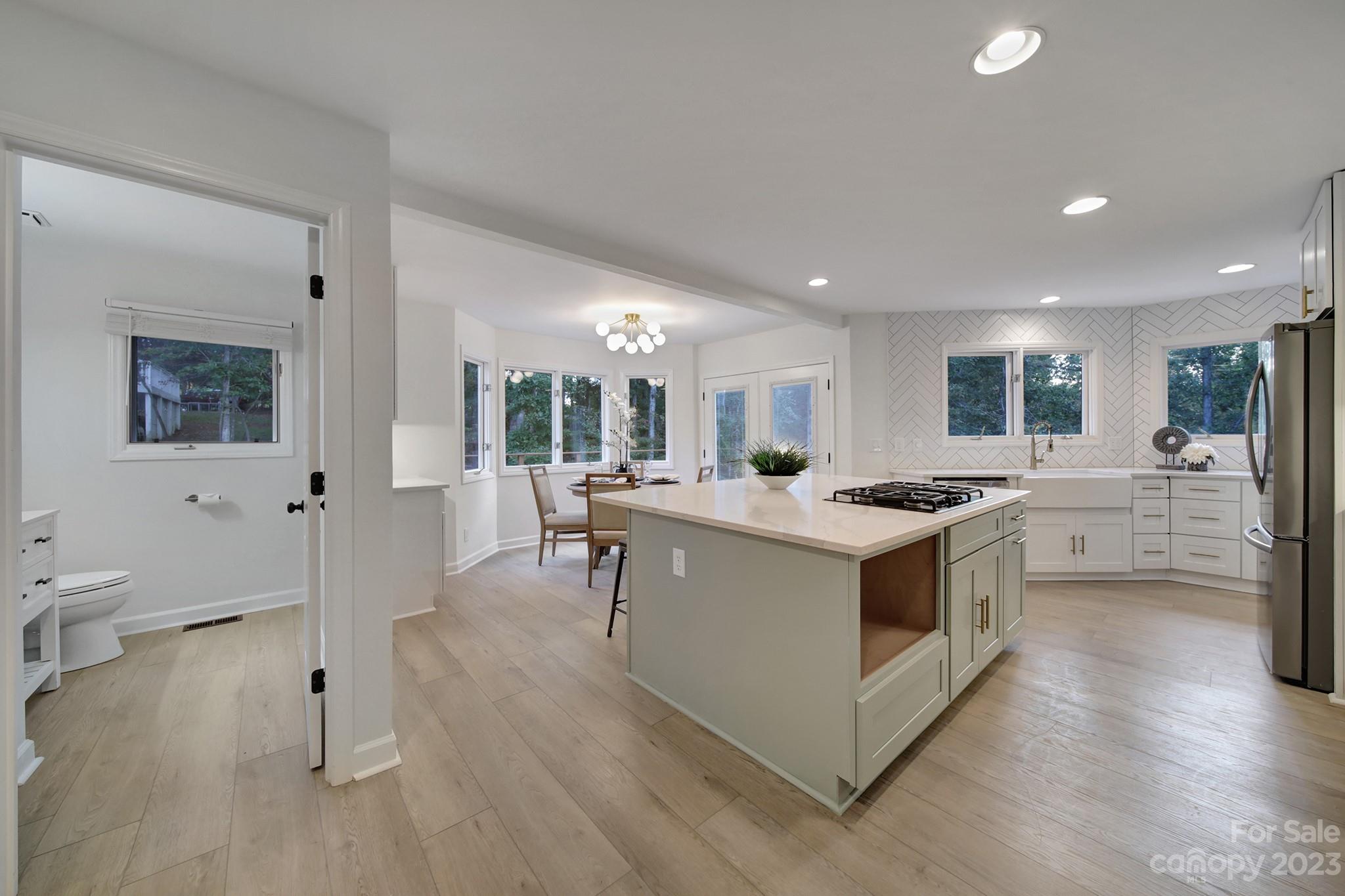 25068 Timberlake Drive Tega Cay, SC 29708 - Photo 11 of 48 a kitchen with stainless steel appliances kitchen island granite countertop a stove and a sink