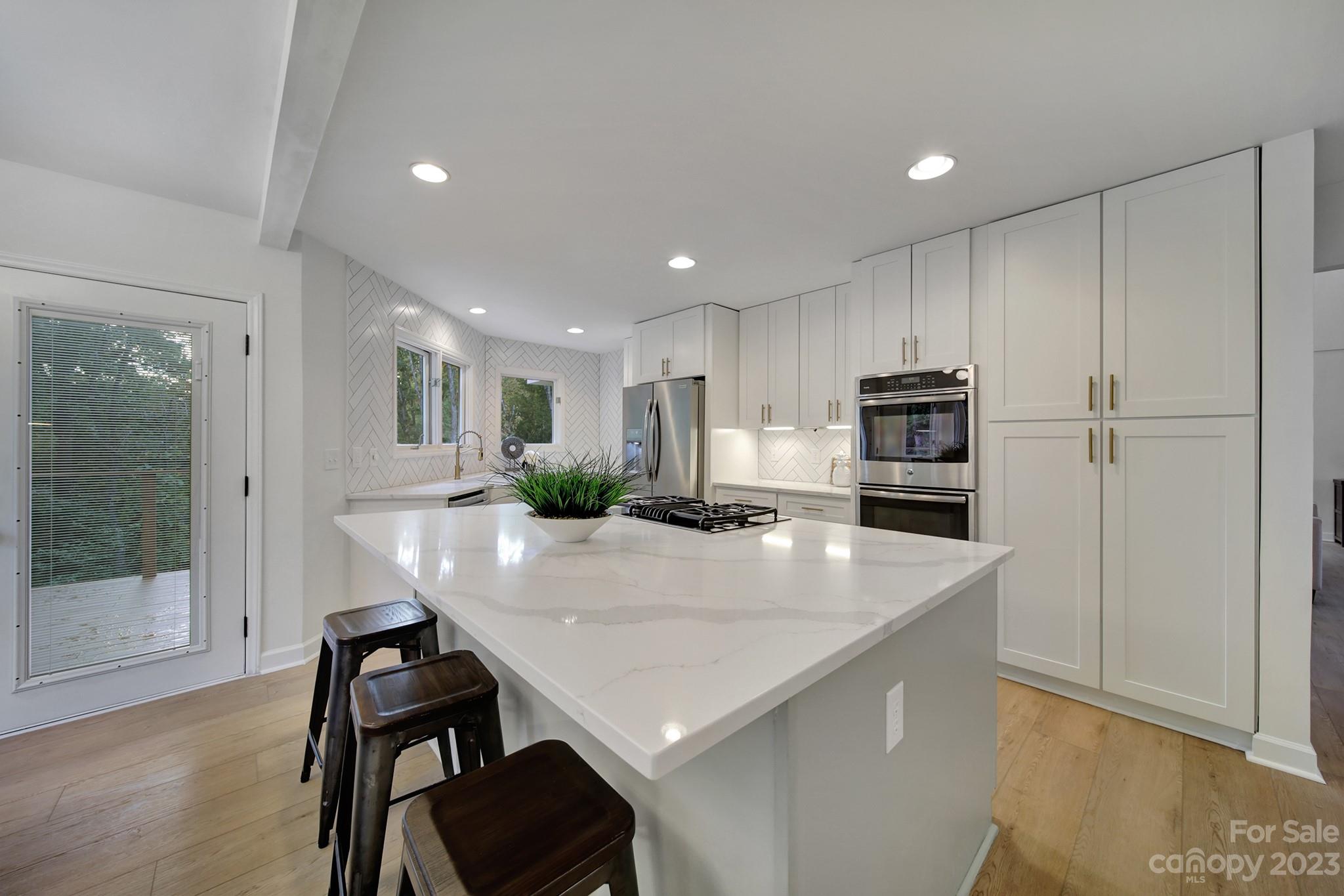 25068 Timberlake Drive Tega Cay, SC 29708 - Photo 12 of 48 a kitchen with appliances cabinets and wooden floor