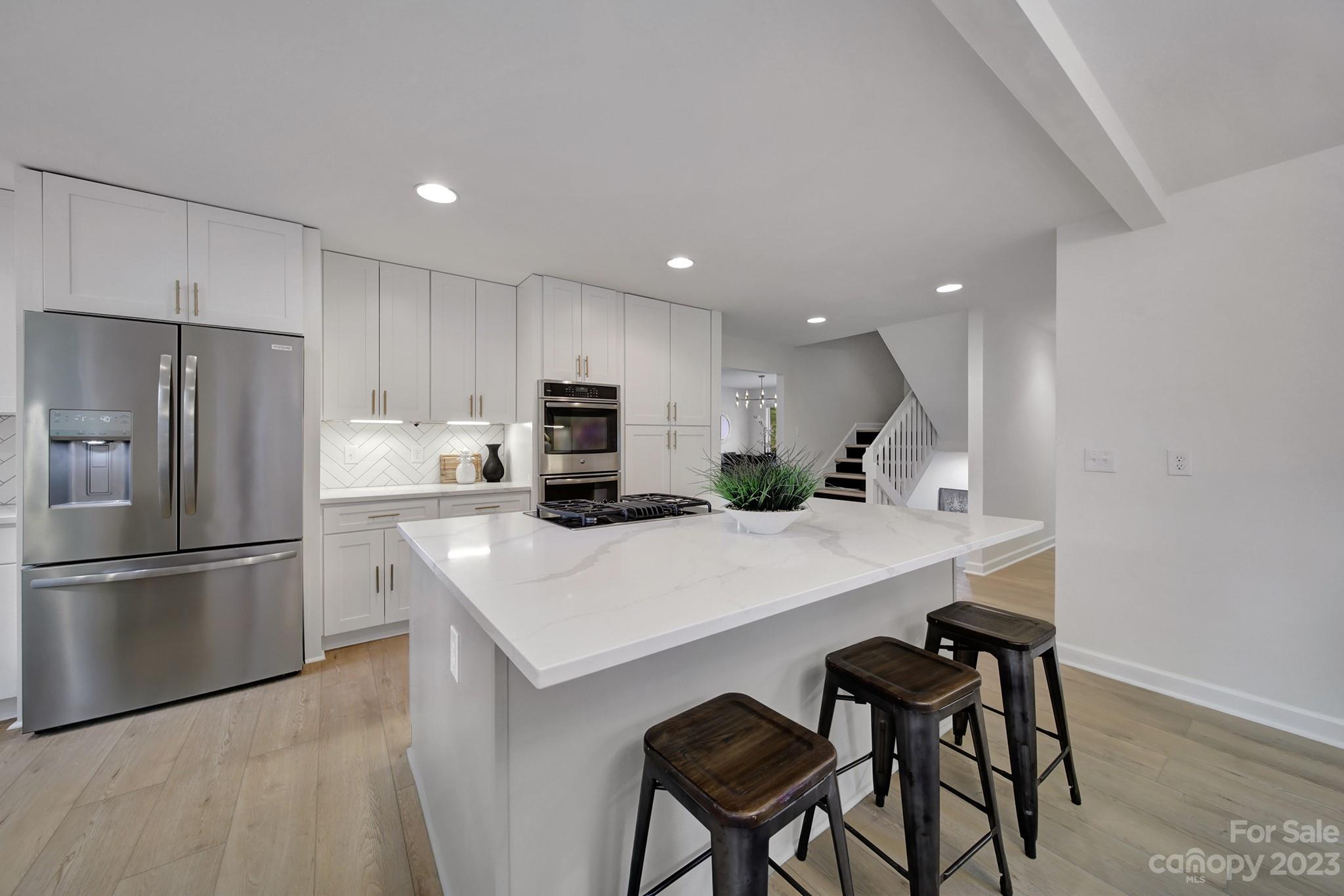 25068 Timberlake Drive Tega Cay, SC 29708 - Photo 14 of 48 a kitchen with a refrigerator a stove a sink and a chairs