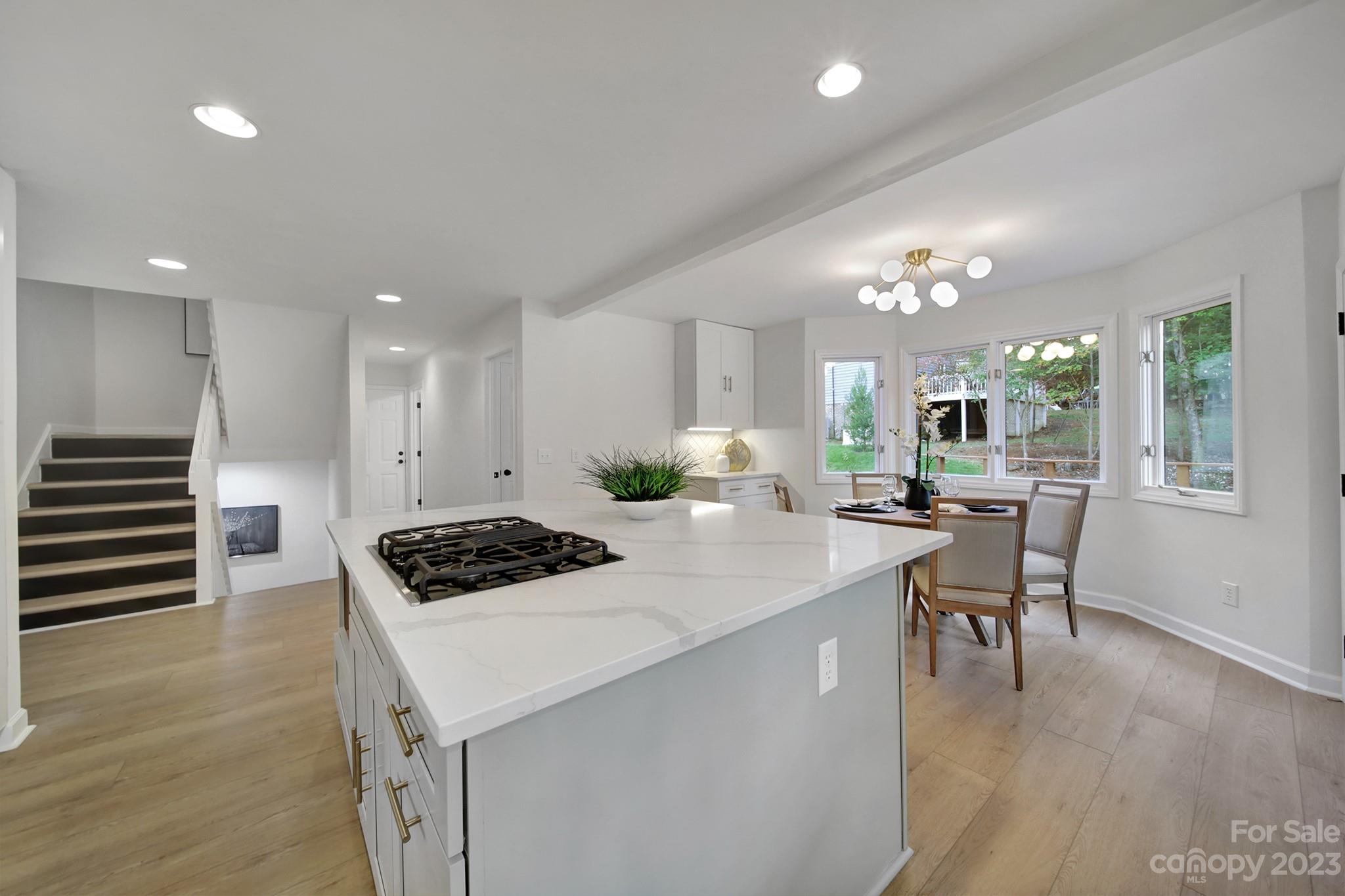 25068 Timberlake Drive Tega Cay, SC 29708 - Photo 15 of 48 a kitchen with kitchen island stainless steel appliances a dining table and chairs