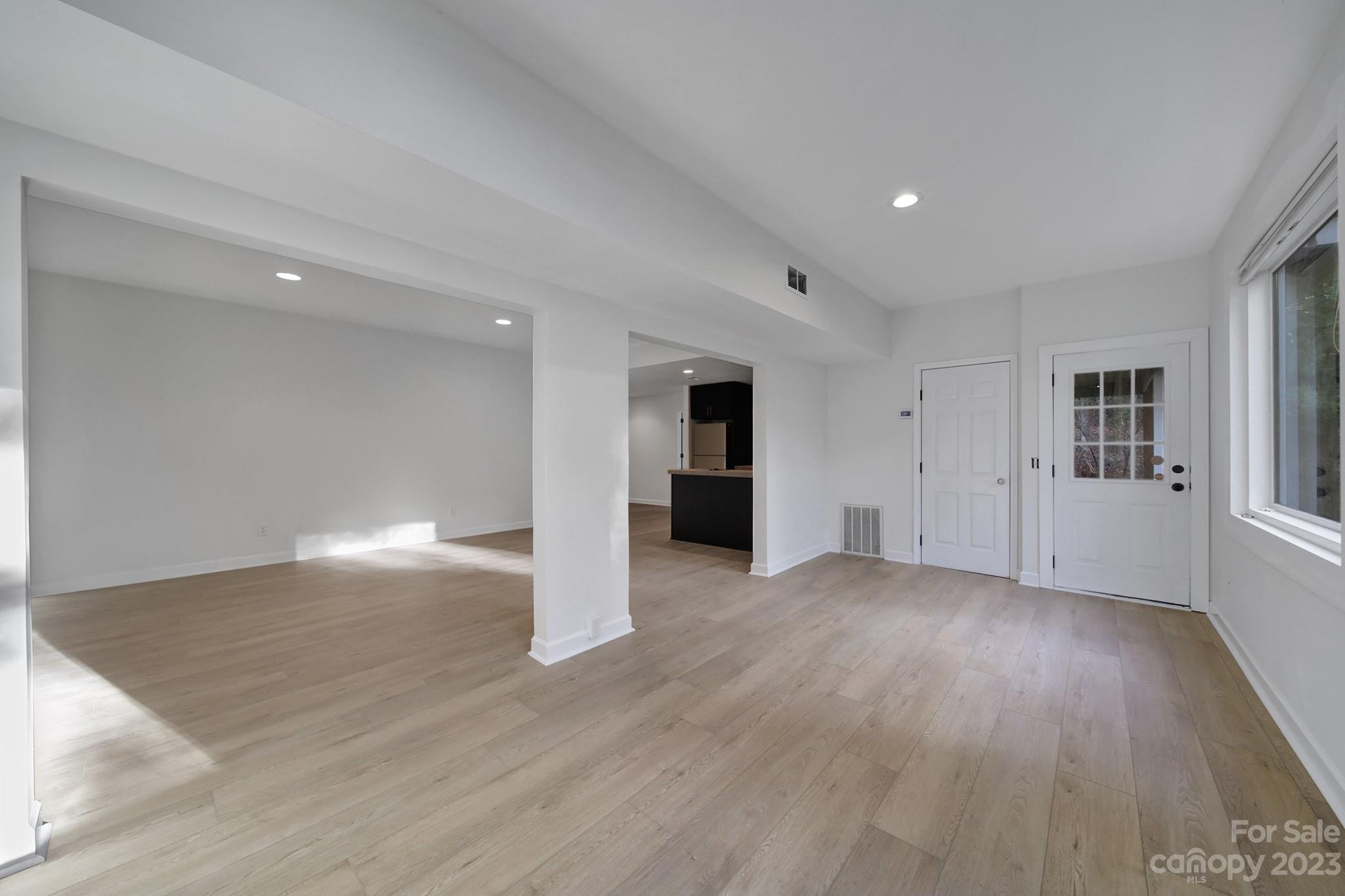 25068 Timberlake Drive Tega Cay, SC 29708 - Photo 21 of 48 a view of empty room with wooden floor and window