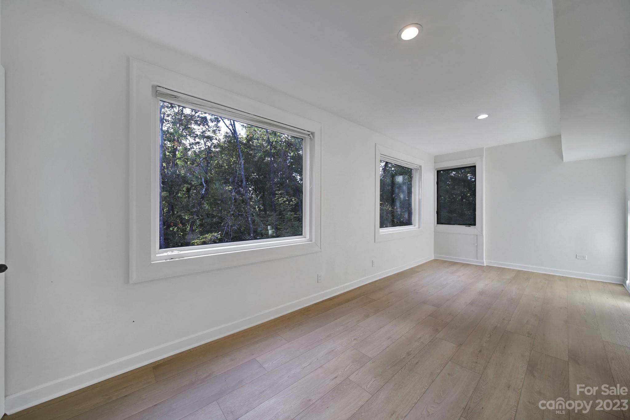 25068 Timberlake Drive Tega Cay, SC 29708 - Photo 22 of 48 a view of an empty room with wooden floor and a window