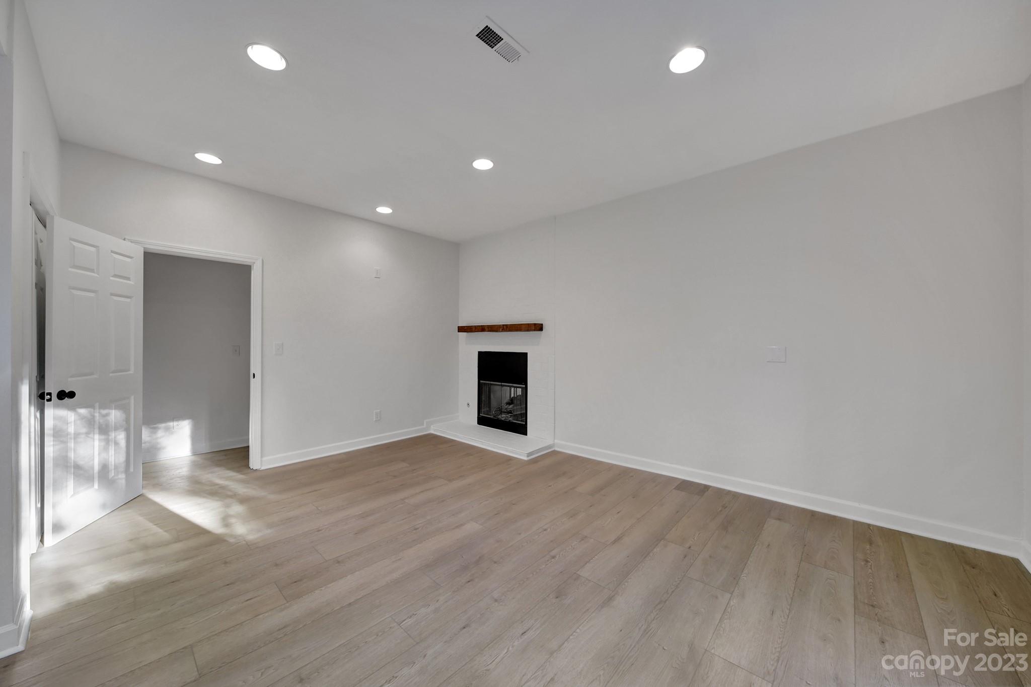 25068 Timberlake Drive Tega Cay, SC 29708 - Photo 24 of 48 an empty room with wooden floor and fireplace