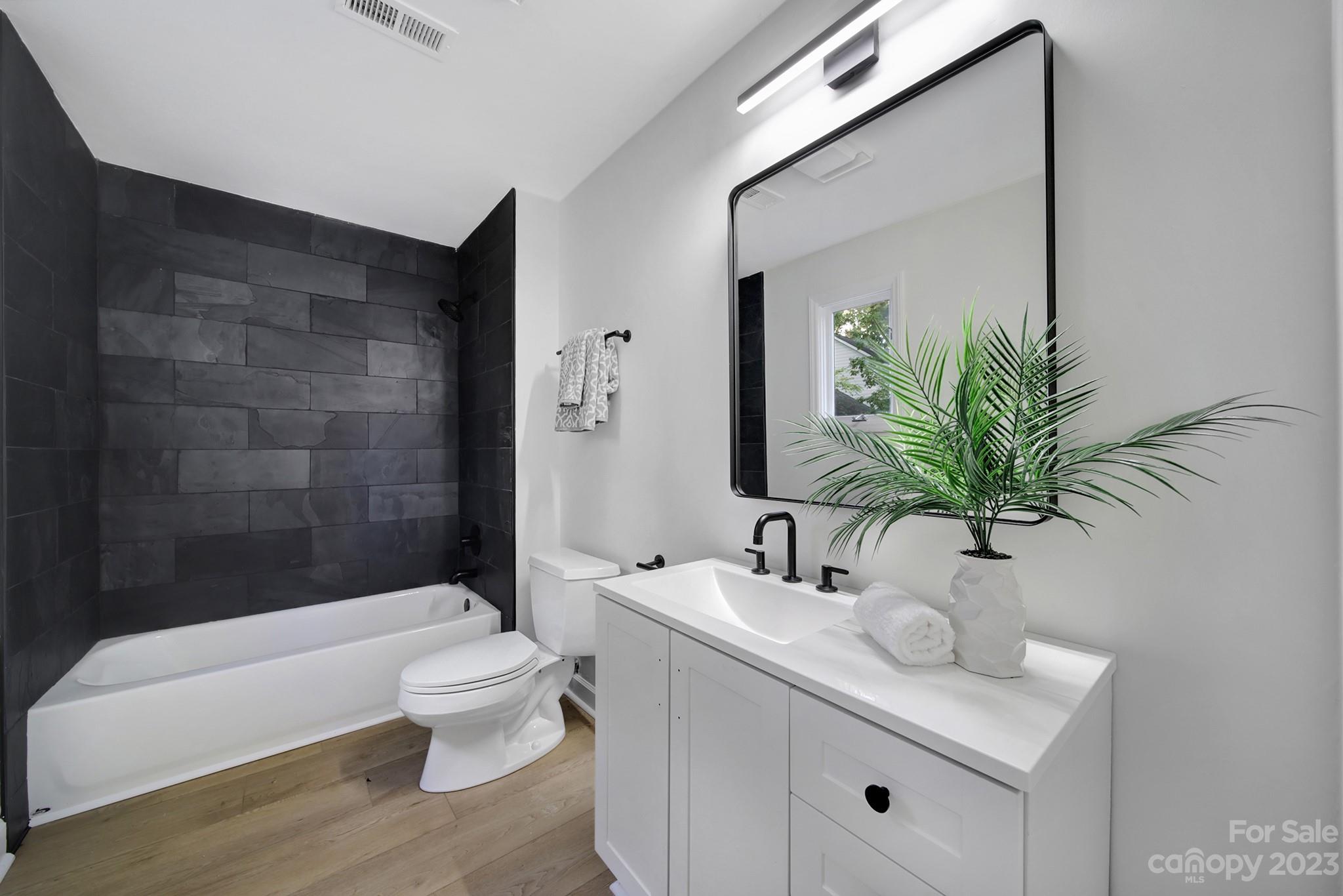 25068 Timberlake Drive Tega Cay, SC 29708 - Photo 25 of 48 a bathroom with a sink a toilet a mirror and shower