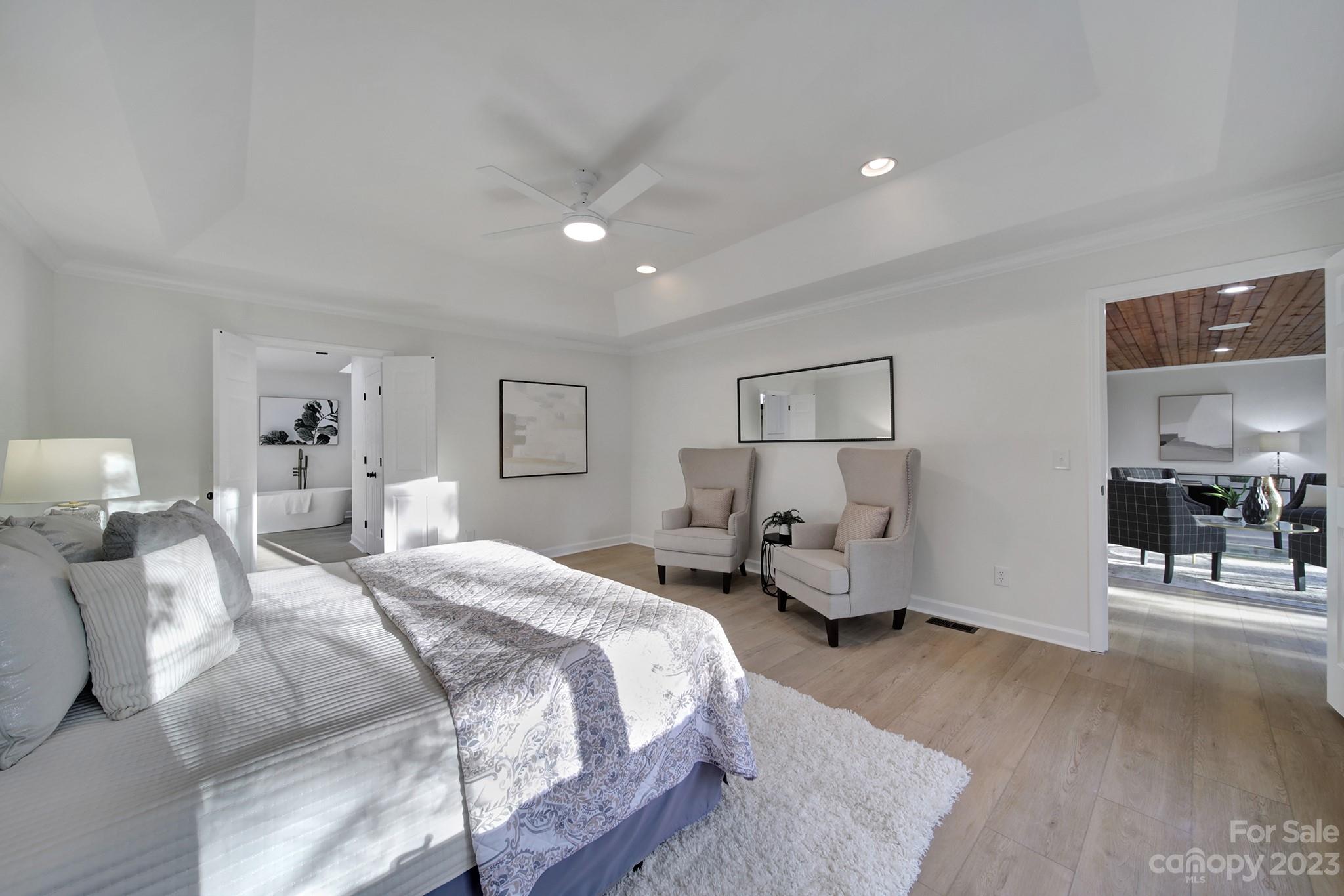 25068 Timberlake Drive Tega Cay, SC 29708 - Photo 36 of 48 a spacious bedroom with a bed and wooden floor
