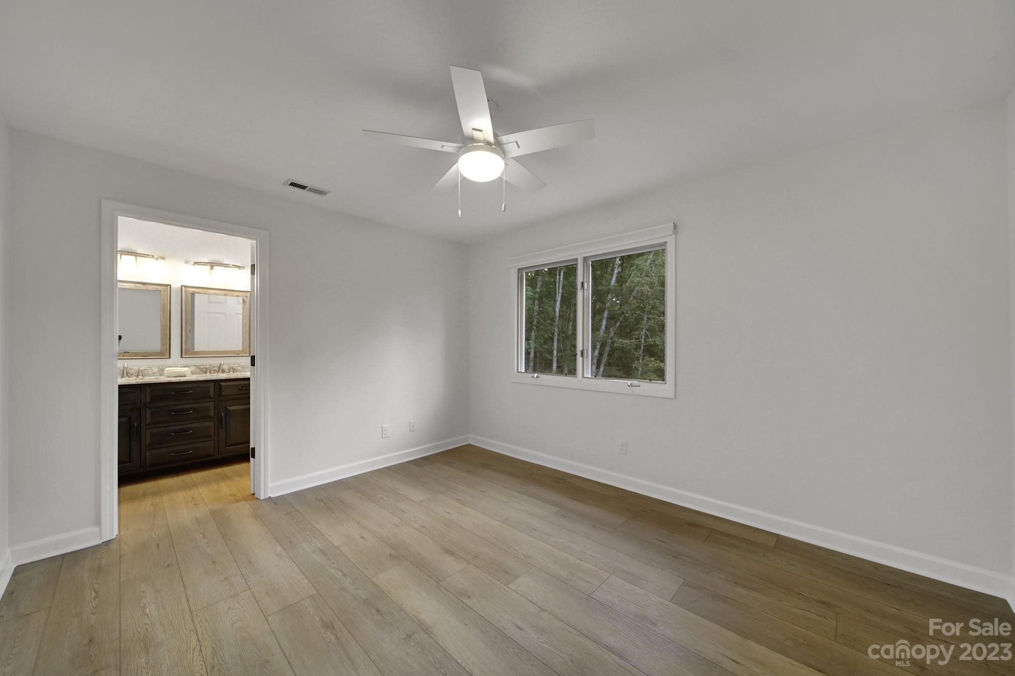 25068 Timberlake Drive Tega Cay, SC 29708 - Photo 41 of 48 a view of an empty room with a window and wooden floor