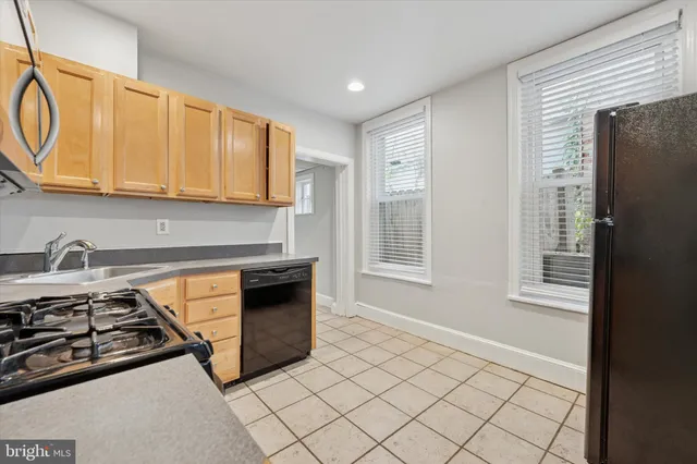 a kitchen with stainless steel appliances granite countertop a stove and a refrigerator