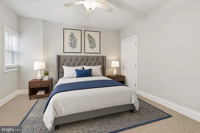 a large bed sitting in a bedroom next to a lamp