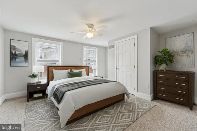 a bedroom with a bed and a potted plant