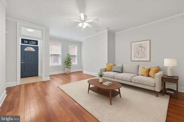 a living room with furniture and wooden floor