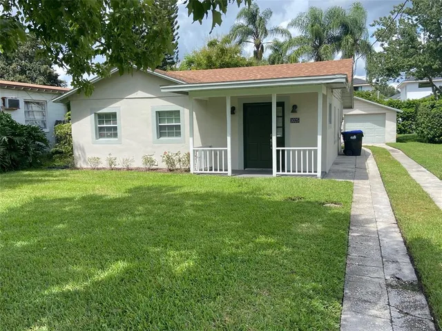 a view of a house with a yard and plants