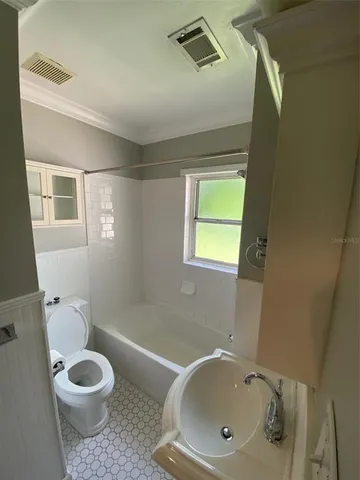 a bathroom with a toilet a sink and bathtub