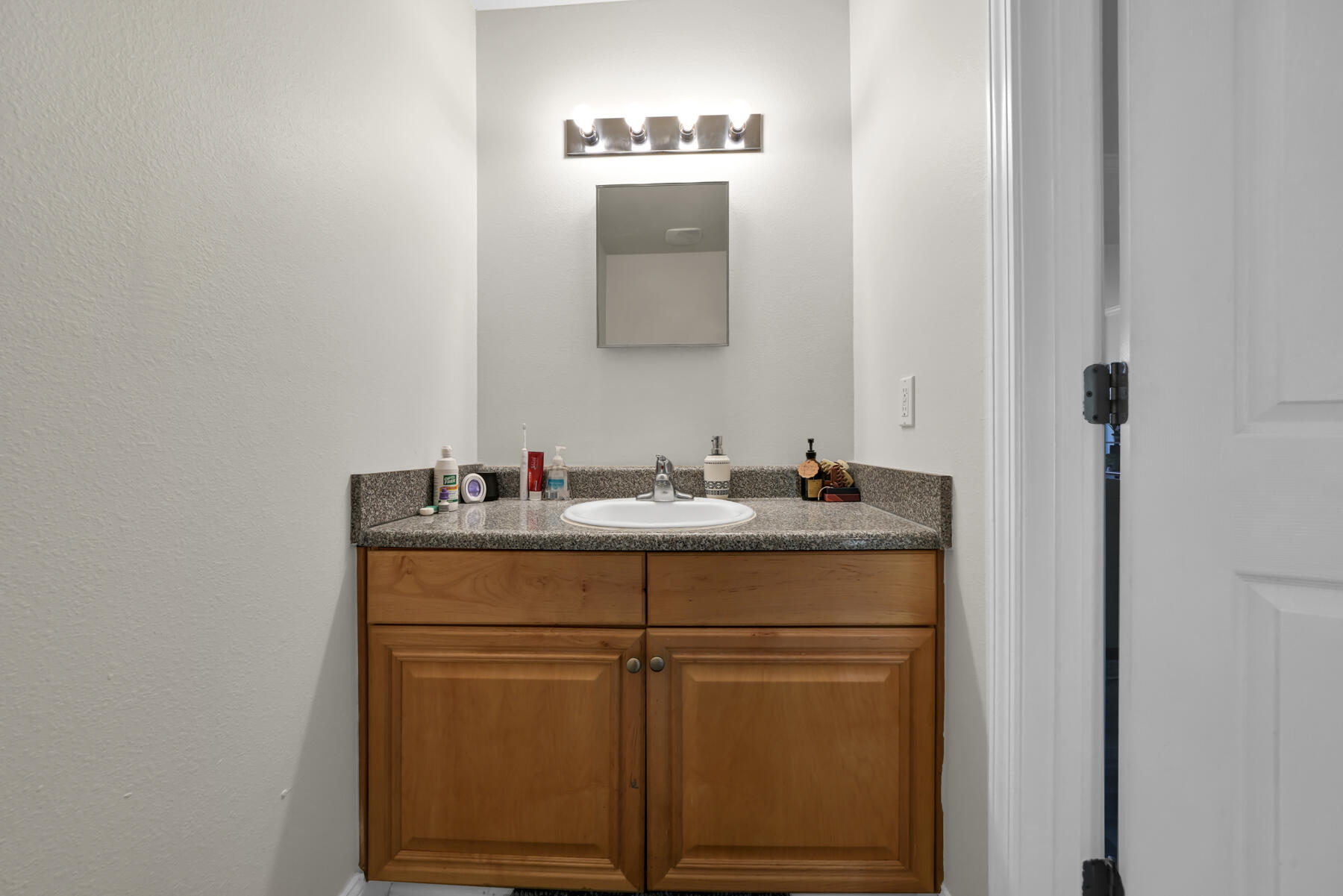 562 Wingspan Way Crestview, FL 32536 - Photo 9 of 23 a bathroom with a sink and a mirror