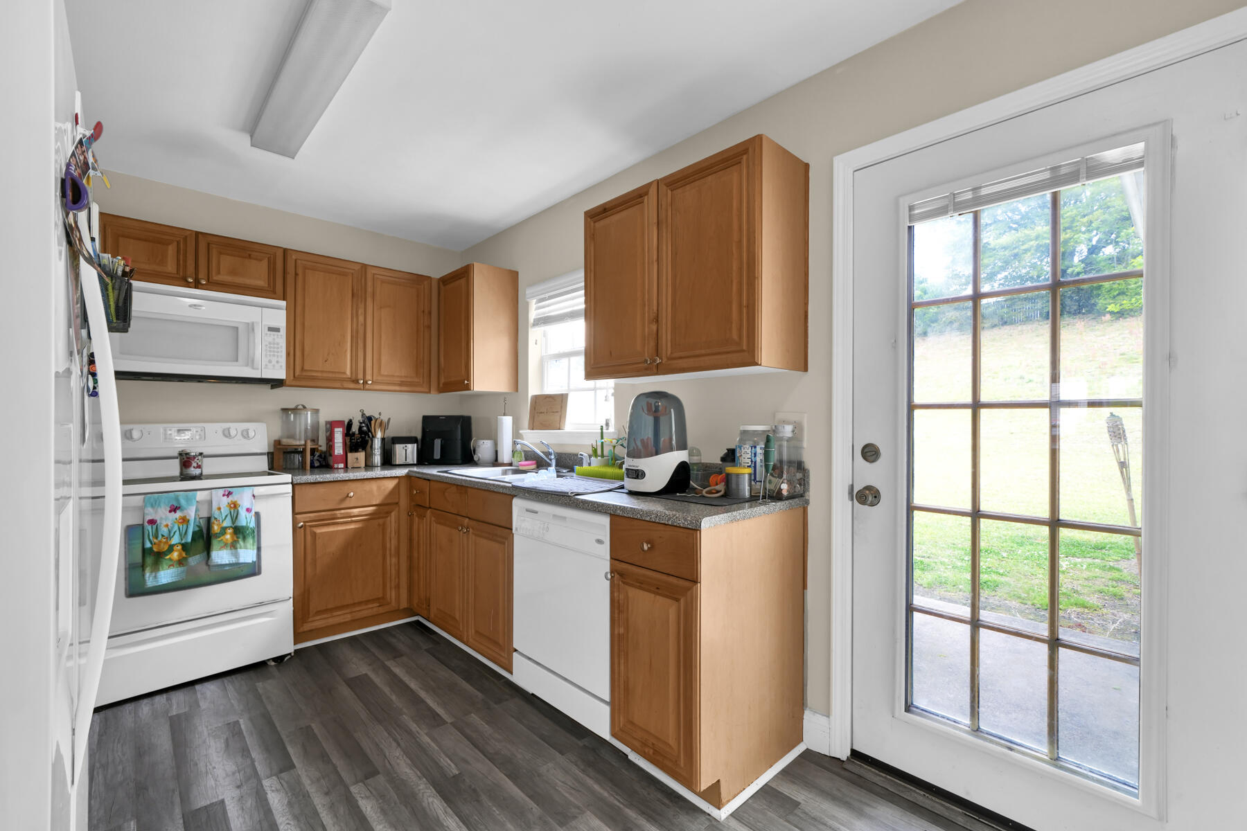562 Wingspan Way Crestview, FL 32536 - Photo 10 of 23 a kitchen with a refrigerator wooden floor window and sink