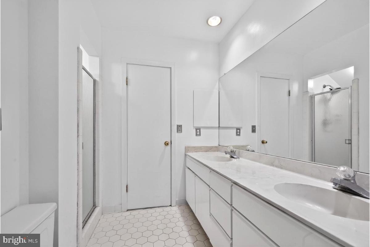 10320 Glen Road Potomac, MD 20854 - Photo 28 of 75 a bathroom with a granite countertop sink and a mirror