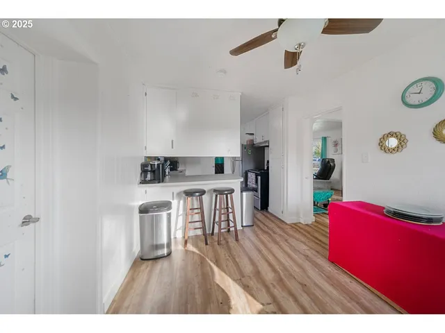 a kitchen with furniture and wooden floor