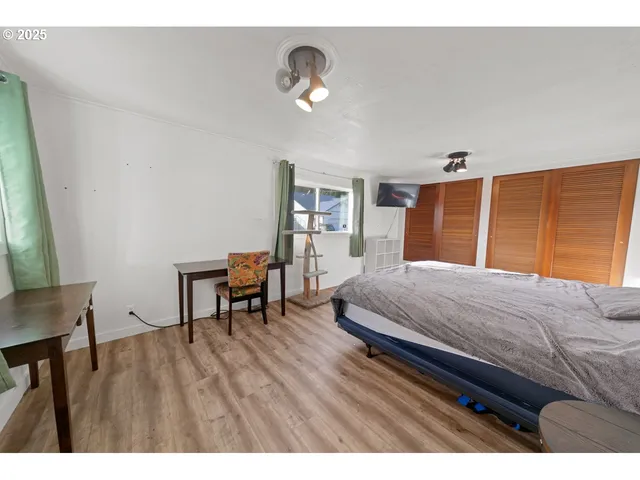 a bedroom with a bed and a desk