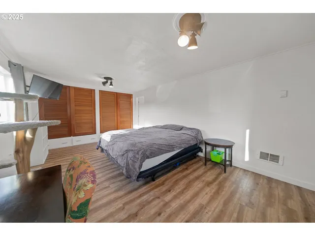 a bedroom with a bed closet and a large window