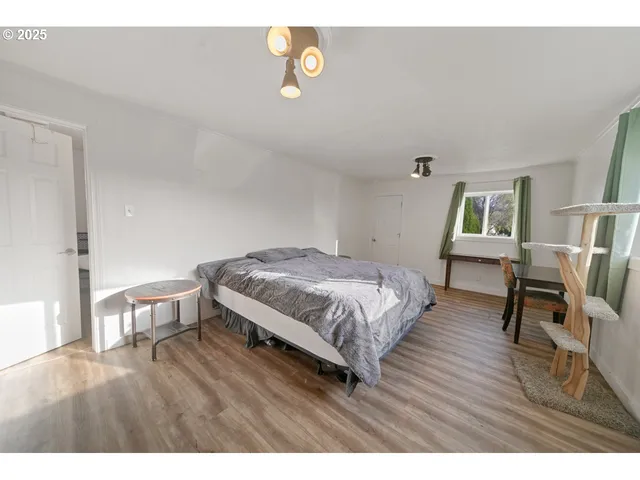 a bedroom with a bed and a table