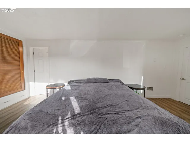 a bedroom with a bed window and table