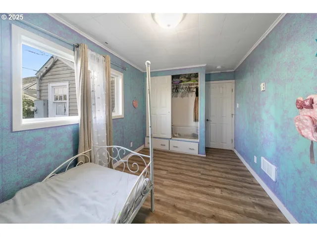 a bedroom with a bed and flat screen tv