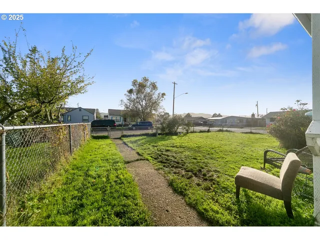 a backyard of a house with table and chairs
