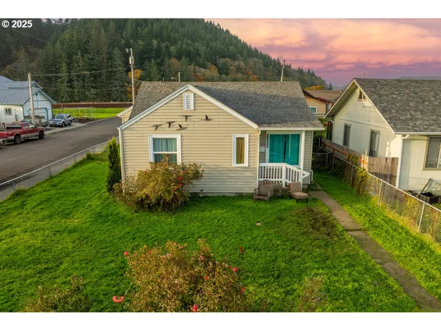 a aerial view of a house with a yard table and chairs