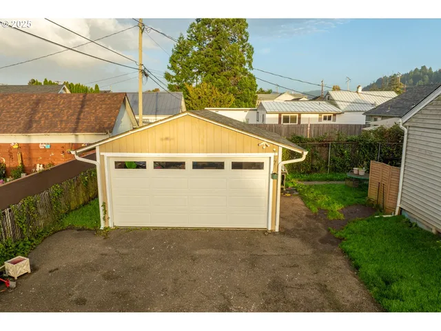 a view of a house with a yard and garage