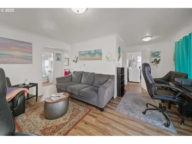 a living room with furniture a piano and a flat screen tv