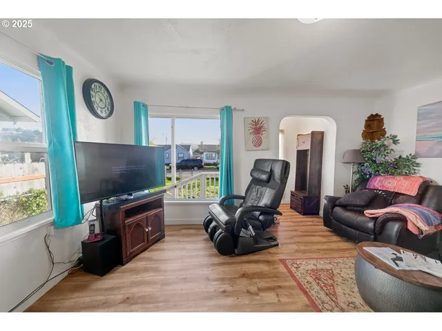 a living room with furniture and a flat screen tv