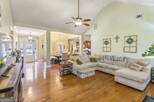 a living room with furniture and wooden floor