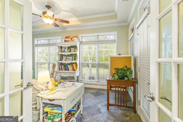 a very nice looking room with a large window a dining table and chairs