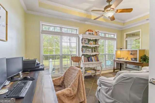 a living room with furniture a flat screen tv and a large window