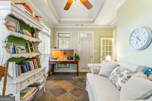 a living room with furniture and a book shelf