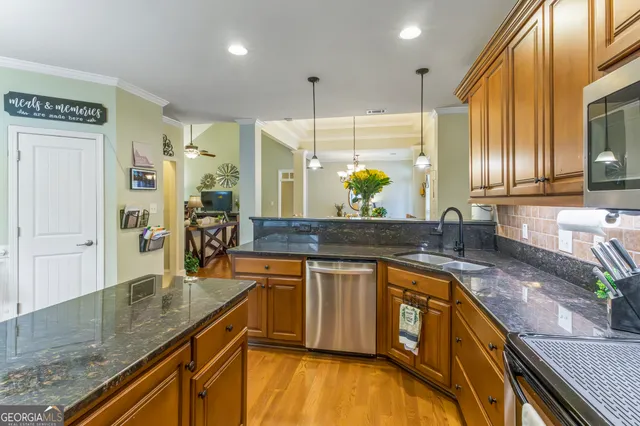a kitchen with stainless steel appliances granite countertop sink stove and cabinets
