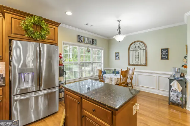 a kitchen with a refrigerator a sink and cabinets