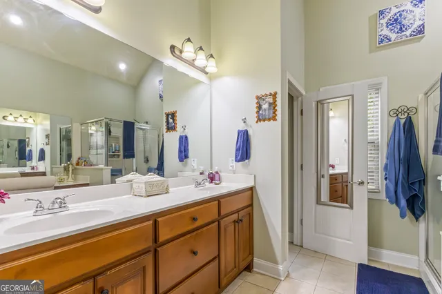 a bathroom with a double vanity sink and a mirror