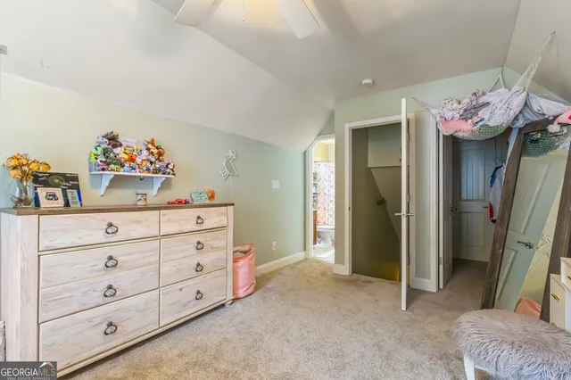 a bed room with a bed and a mirror