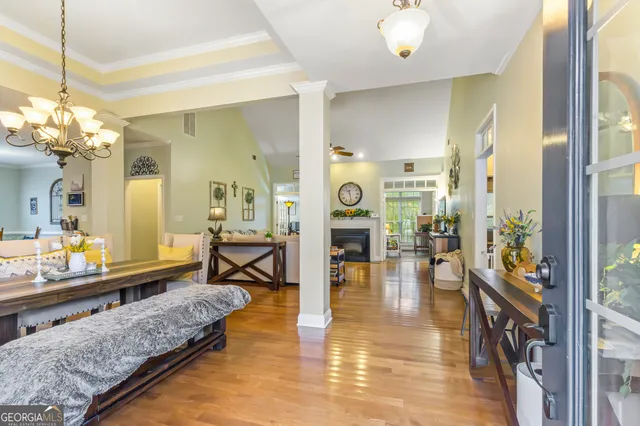 a living room with furniture and a chandelier