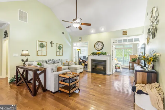 a living room with furniture a fireplace and a flat screen tv